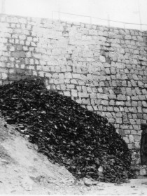 At Flossenburg, members of the 358th Infantry stare in shock at a seemingly endless pile of shoes, removed from dead prisoners before their bodies were burned - April 1945. (U.S. Army Signal Corps Photo, Courtesy National Archives)